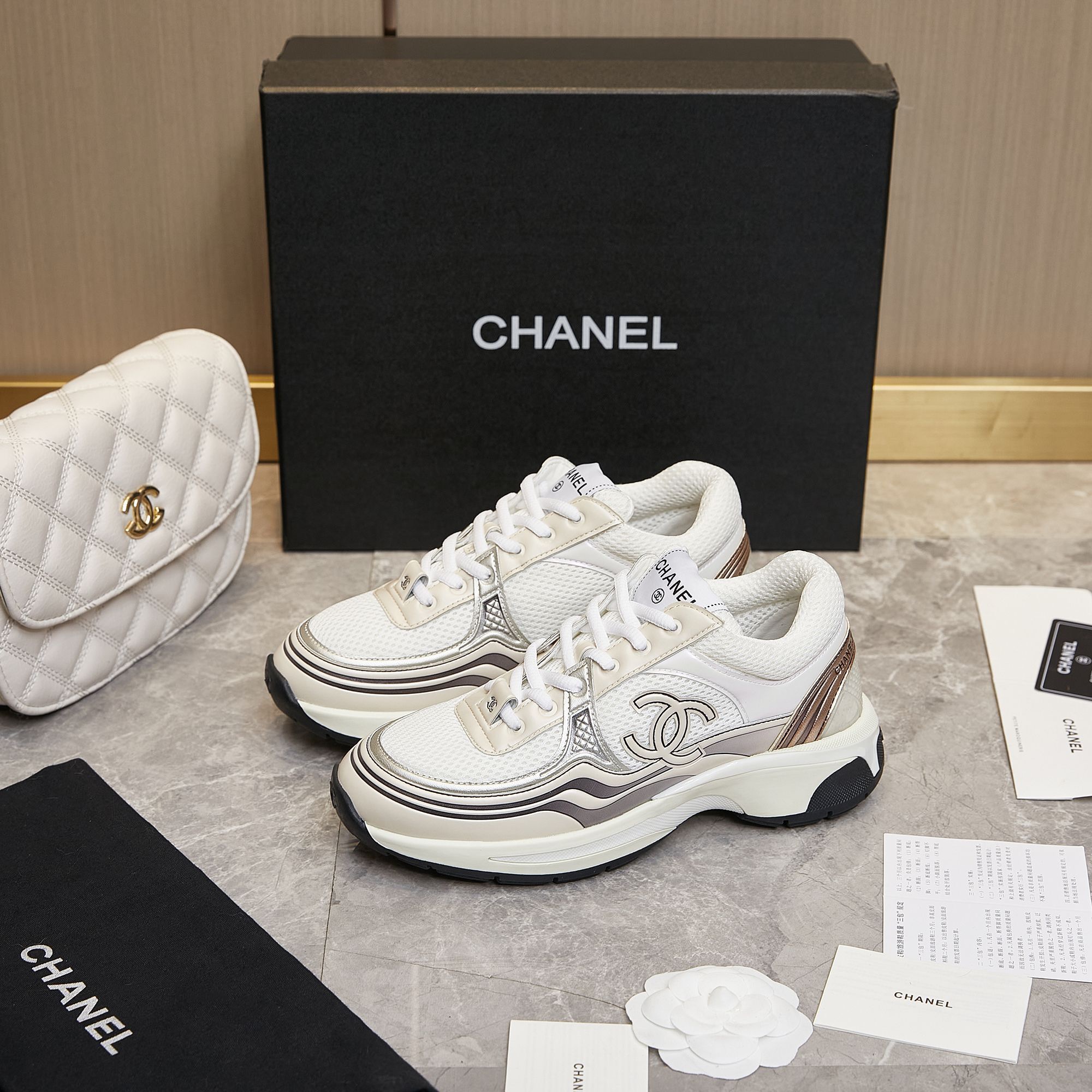 CHANEL Gold and silver horn king sneakers